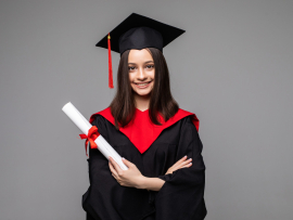 Happy student with graduation hat and diploma on grey background. Space for text